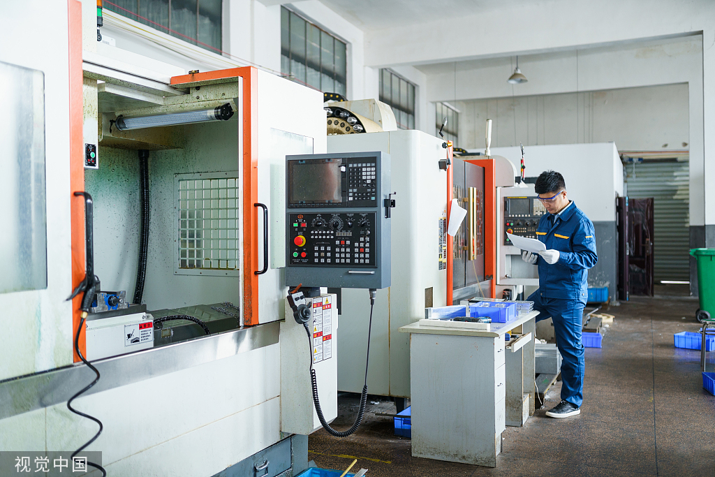 Modern workshop interior, workers operating precision equipment, clean and orderly production environment, reflecting corporate strength
